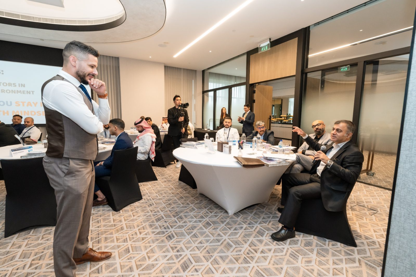 Andrew Wolhuter facilitating a leadership session around boardroom tables